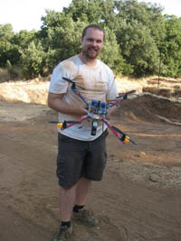 An ASOR fellow holds a small aerial photography helicopter.